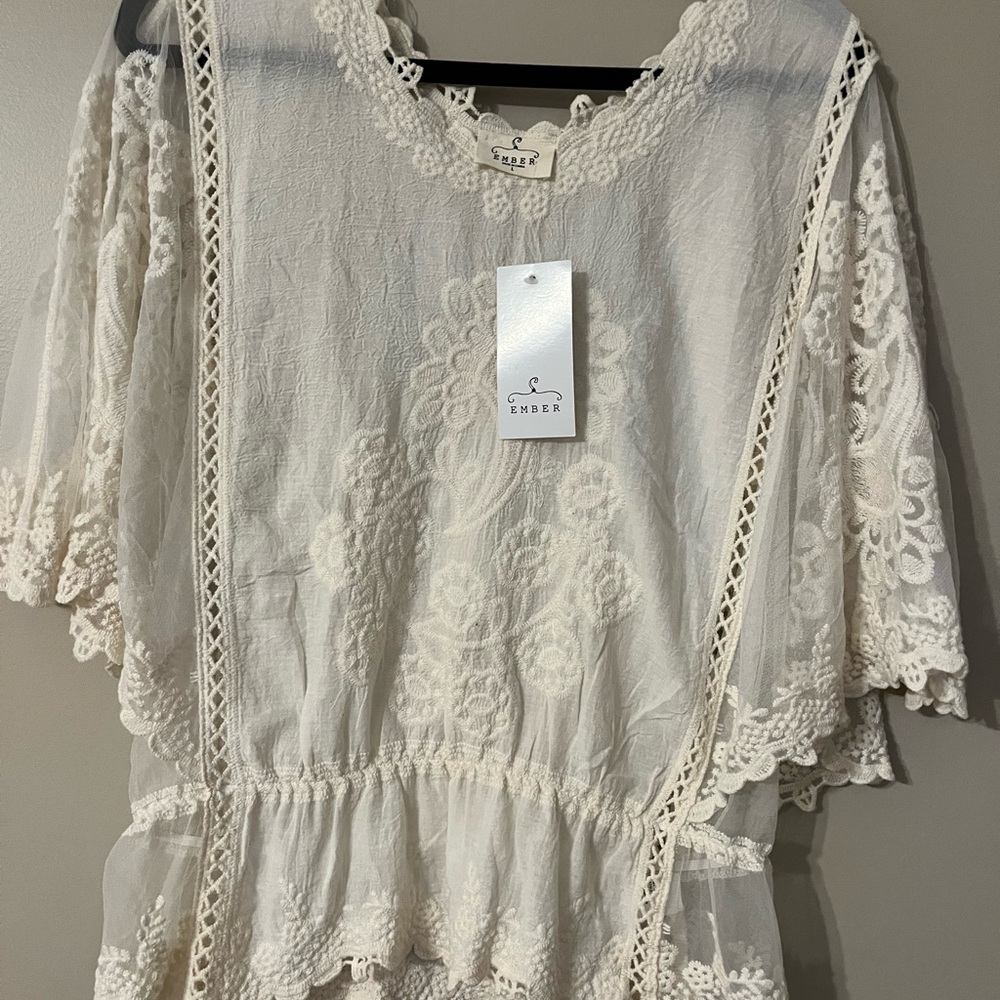 Cream colored lace top, sheer sides.